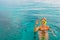 Young woman in snorkeling mask showing divers sign OK