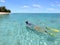 Young woman snorkelling in a lagoon in Rarotonga Cook Islands