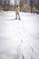 Young woman in snow shoes walking in winter forest