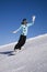 Young woman on snowboard on the slope of mountain