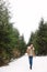 Young woman in snowy conifer forest. Winter