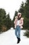 Young woman in snowy conifer forest. Winter