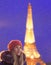 Young woman at the snowy Paris near eiffel tower at night
