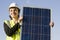 Young woman with a solar panel