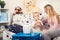 Young woman with son doing inhalation with a nebulizer at home.