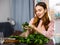 Young woman sorts fresh spinach