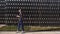 Young woman spends time in a park waiting for someone. Student is drinking coffee in the park