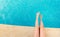 Young woman splashing feet in pool