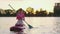 Young woman in sport clothes swimming on paddle board