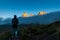 Young woman in sport clothes watching sunrise on mountain rock towers of Langkofel Group, Grohmannspitze mountain,