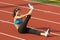 Young Woman in Sports Bra Stretching Raised Leg on Running rack