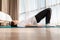 Young woman in sports clothes doing yoga in the bedroom. Windows in the background. Yoga at home. Side view from below. Copy space