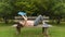 Young woman in sportswear lying on the wooden bench reading a book