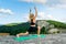 Young woman in sportswear trains in the mountains. The concept of yoga, fitness, meditation