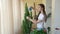 Young woman spraying plant.