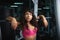 Young woman stand next to barbell