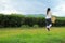 Young woman stand in the tea plantation surrounded by sky and mountain view. Singha Park Tea Plantation at Chiangrai, Thailand