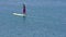 Young Woman Stand Up Paddle Boarding in Blue Lake