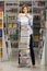 Young woman standing with big stack of books