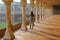 Young woman standing in colonnade walkway leading to Diwan-i- Khas in Agra Fort, Uttar Pradesh, India