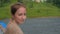 Young woman standing on deck of cruise ship and looking at river and landscape