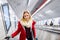 Young woman standing at the escalator in Vienna subway