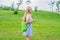 Young woman standing with folded inflatable sofa in the park. lamzac