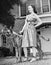 Young woman standing with her Great Dane in a courtyard