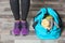 Young woman standing near sports bag