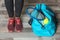 Young woman standing near sports bag