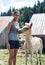 Young woman standing petting a foal