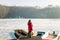 Young woman standing on the pier of a frozen lake