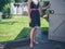 Young woman standing by a shed in garden