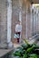 A young woman standing among the stone columns in Paddington Reservoir Gardens, Sydney, Australia