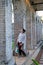 A young woman standing among the stone columns in Paddington Reservoir Gardens, Sydney, Australia