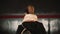 Young woman standing in the subway platform against the background of passing train. Girl waiting metro to go to job.