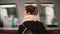 Young woman standing in the subway platform against the background of passing train. Girl waiting metro to go to job.