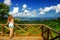 Young woman standing at the viewpoint in Bouma National Heritage