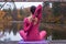 Young woman standing in yoga posture on wooden bridge in autumn