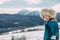 Young woman stands against beautiful landscape of snowbound Carpathians mountains