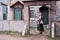 Young woman stands at the gates of a retro medieval church in wild west, America. Vintage clothes on Halloween style 18-19th