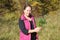 A young woman stands with medicinal herbs in her hands. Caucasus, Russia