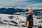 Young woman stands and meditates against beautiful landscape of mountains