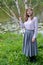 The young woman stands near the blossoming birch of useful Himalaya Betula utilis D. Don