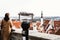 Young woman stands on an observation deck and looks at the old city.