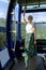 A young woman stands in the spacious cabin of the cable car on a clear summer day.