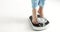 Young woman stepping on an old fashioned scale