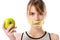 young woman with stick tape with striked through word food covering mouth holding apple