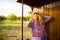 Young woman in straw hat traveling by retro wooden train.