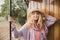 Young woman in straw hat traveling by retro wooden train.